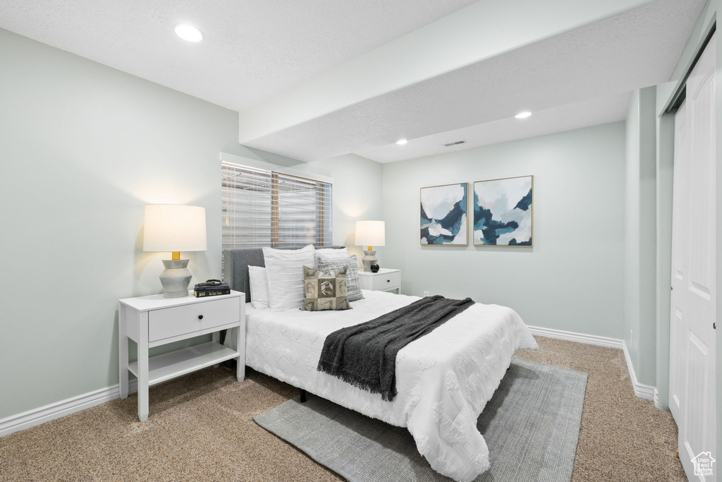 Bedroom with recessed lighting, baseboards, carpet floors, and a closet
