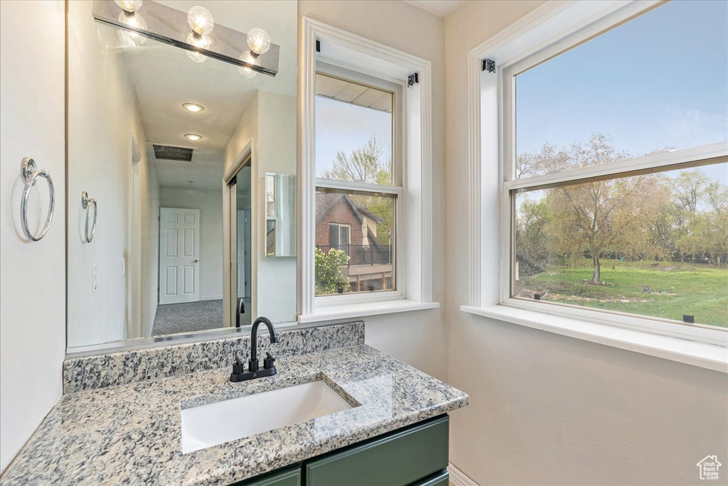 Bathroom with a wealth of natural light and vanity