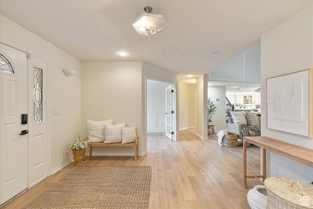 Foyer featuring stairway, baseboards, recessed lighting, and light wood-style flooring