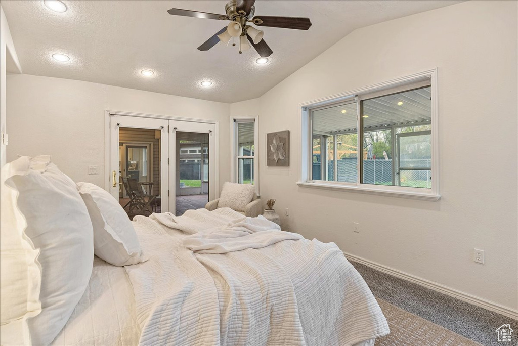 Carpeted bedroom featuring baseboards, recessed lighting, ceiling fan, and vaulted ceiling