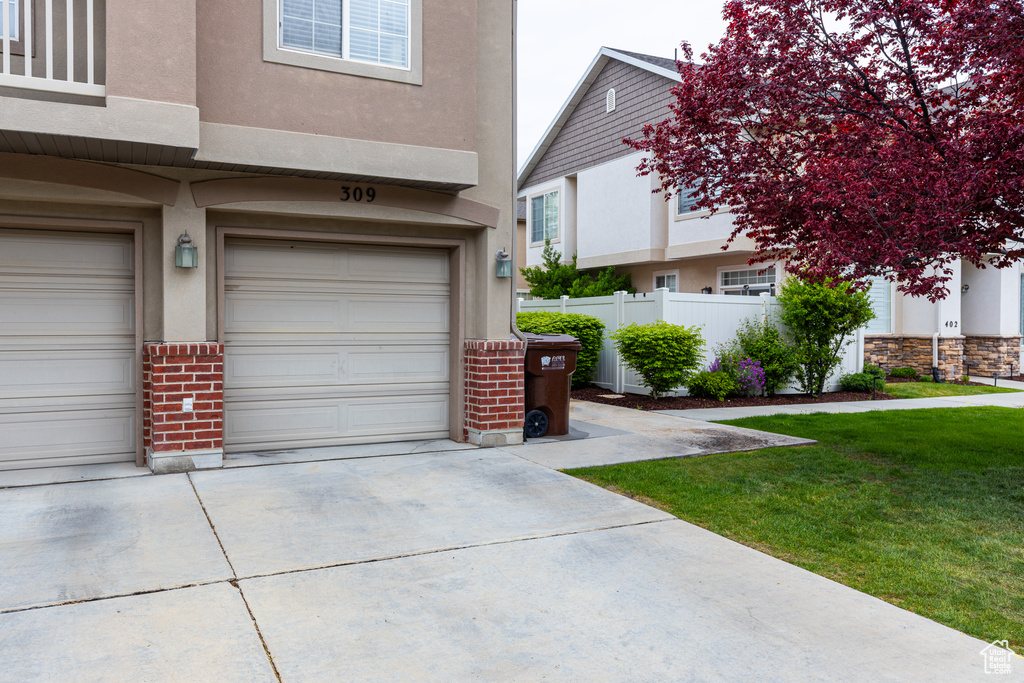Garage with fence and driveway