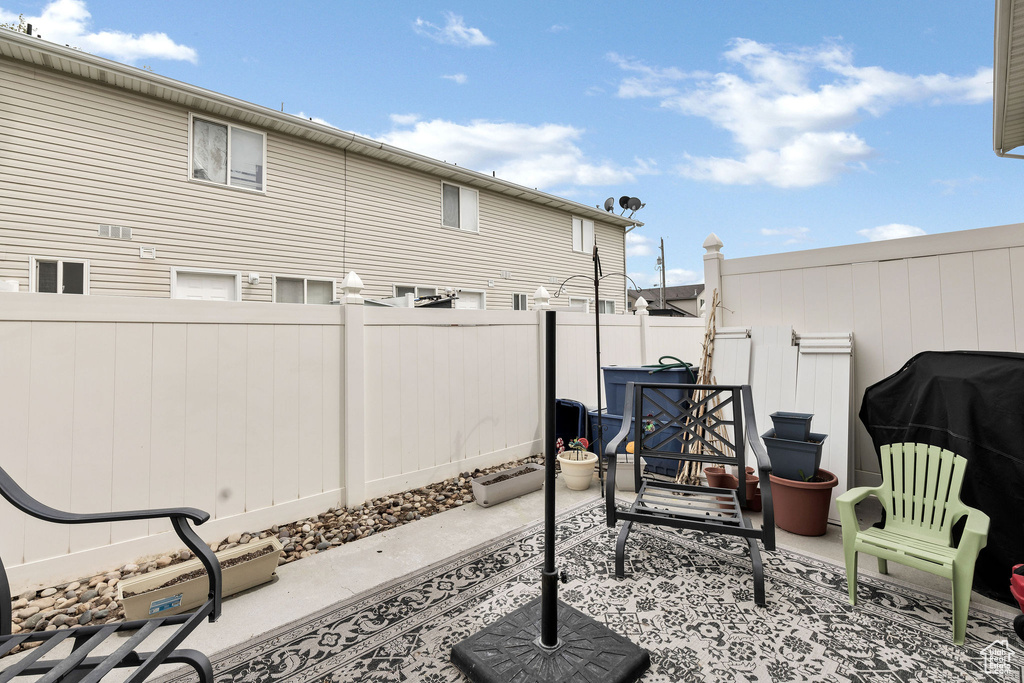 View of patio featuring fence
