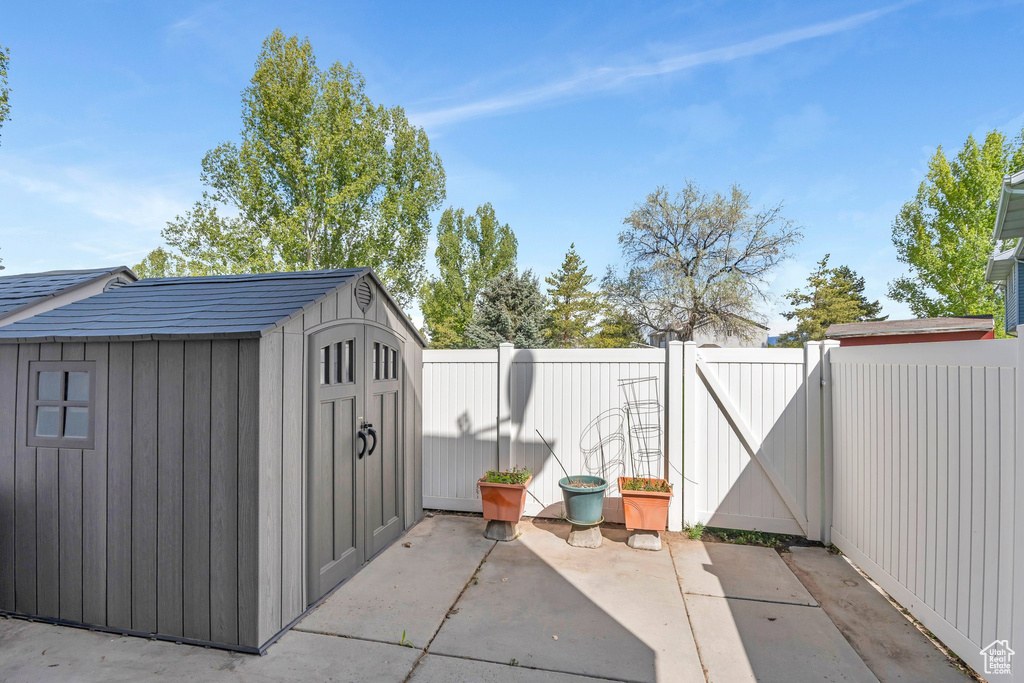 View of shed featuring a gate and a fenced backyard