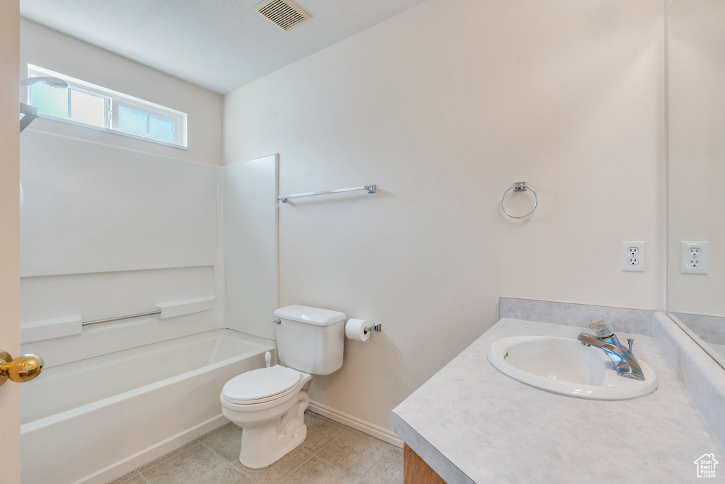 Full bath with tile patterned flooring, bathtub / shower combination, vanity, toilet, and visible vents