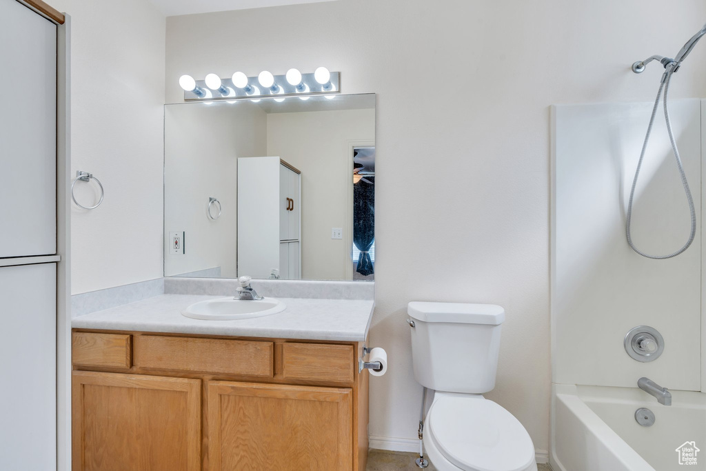 Bathroom with toilet, bathtub / shower combination, and vanity