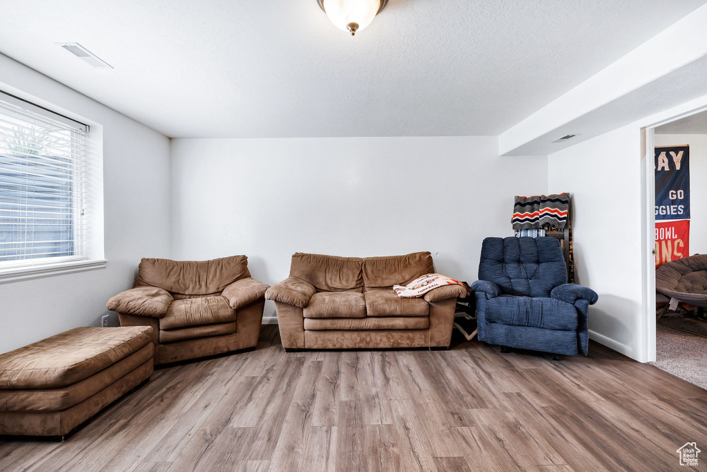 Living area with wood finished floors and visible vents