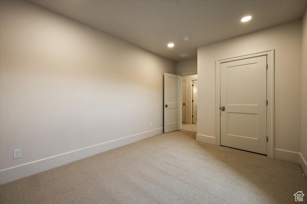 Unfurnished room featuring light colored carpet, recessed lighting, and baseboards