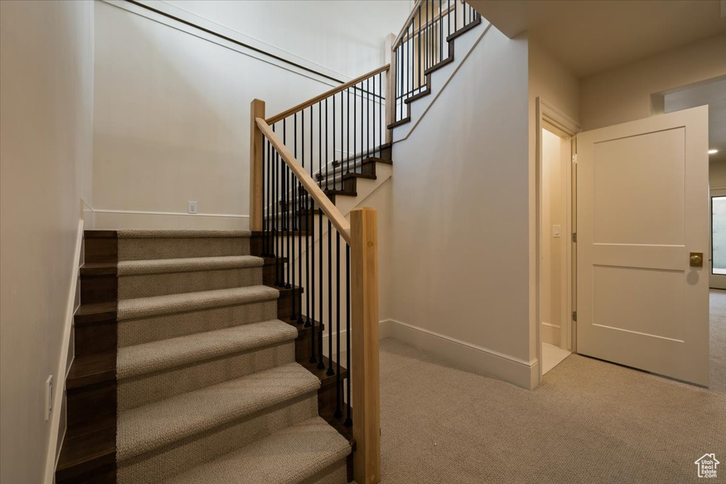 Stairs featuring carpet flooring and baseboards