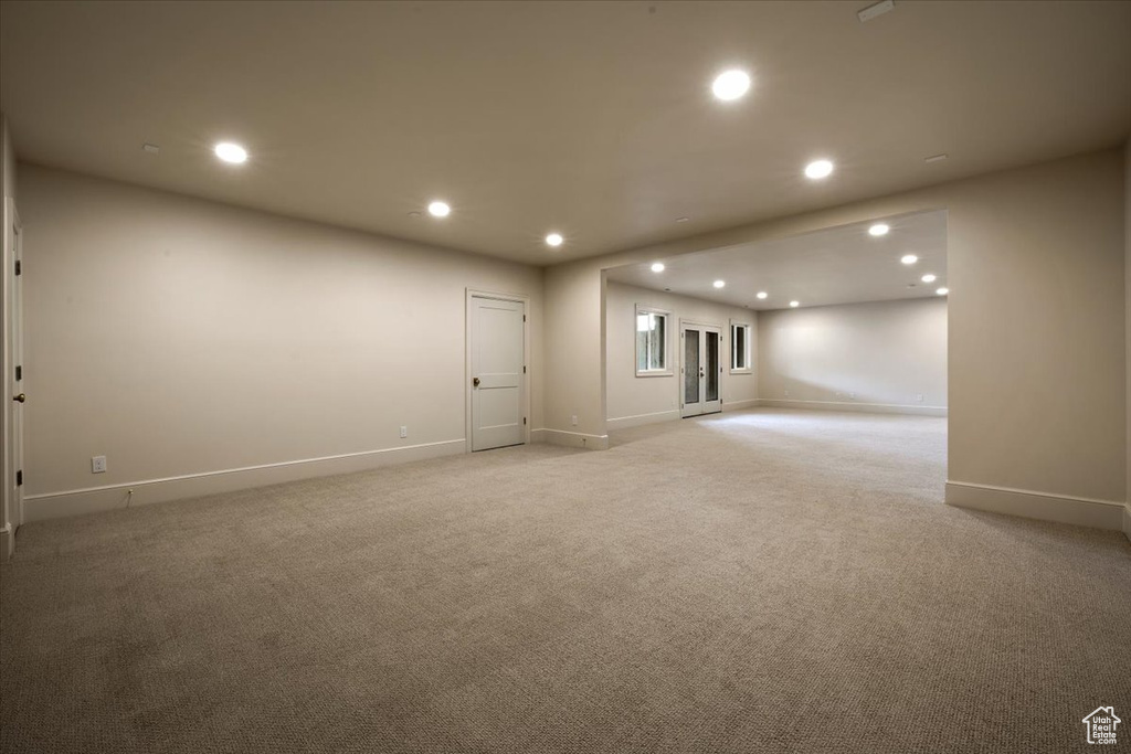 Spare room with baseboards, recessed lighting, and light colored carpet