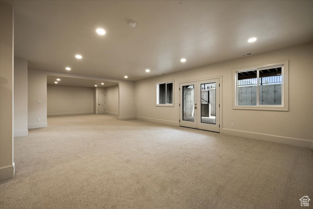Empty room featuring recessed lighting, baseboards, and light colored carpet