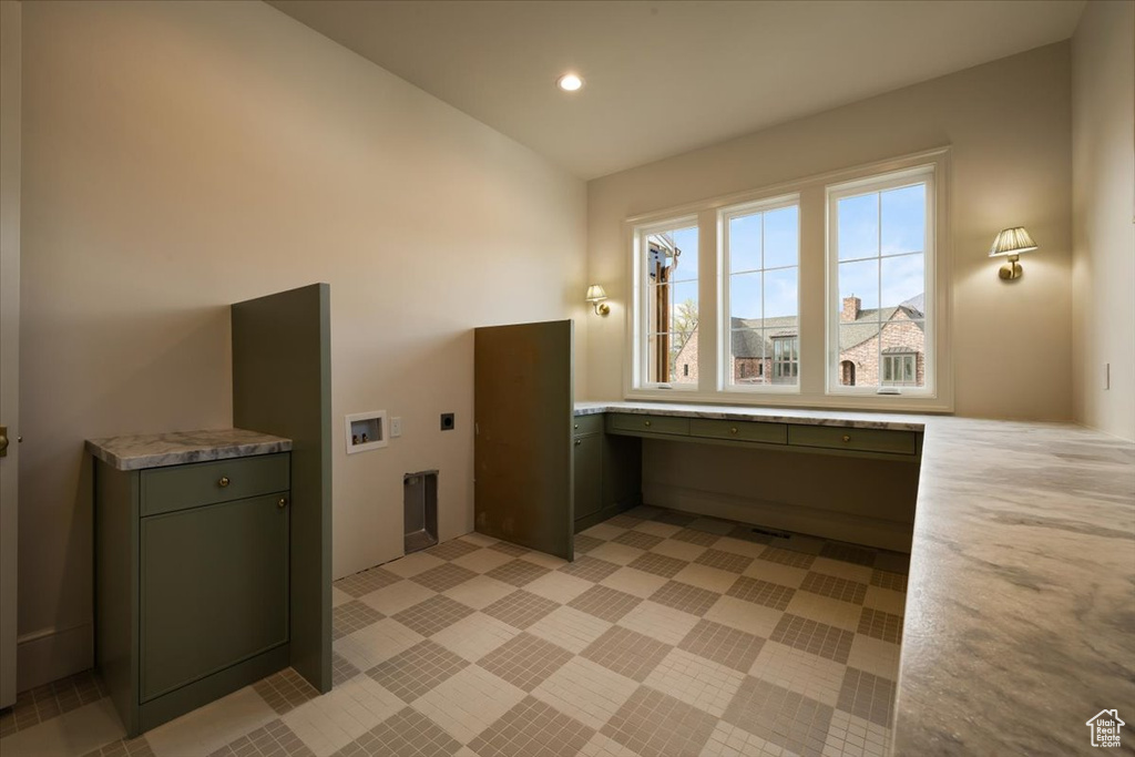 Washroom with electric dryer hookup, hookup for a washing machine, cabinet space, and recessed lighting