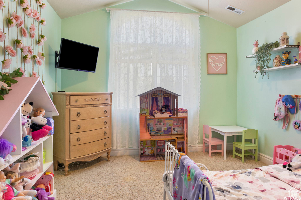 Bedroom with visible vents, carpet flooring, baseboards, and lofted ceiling