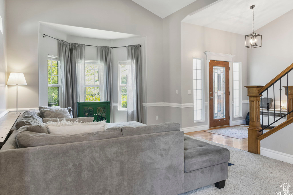 Living area featuring stairs, lofted ceiling, and a wealth of natural light