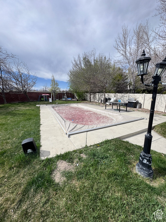 View of community featuring a yard and fence