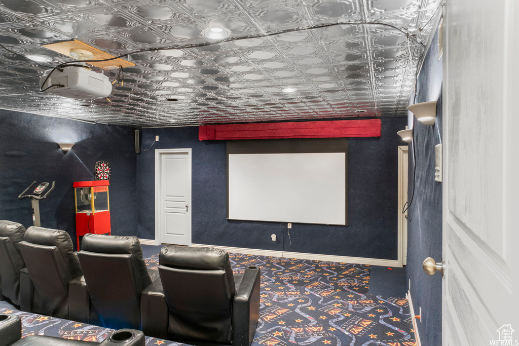 Home theater room with an ornate ceiling and baseboards