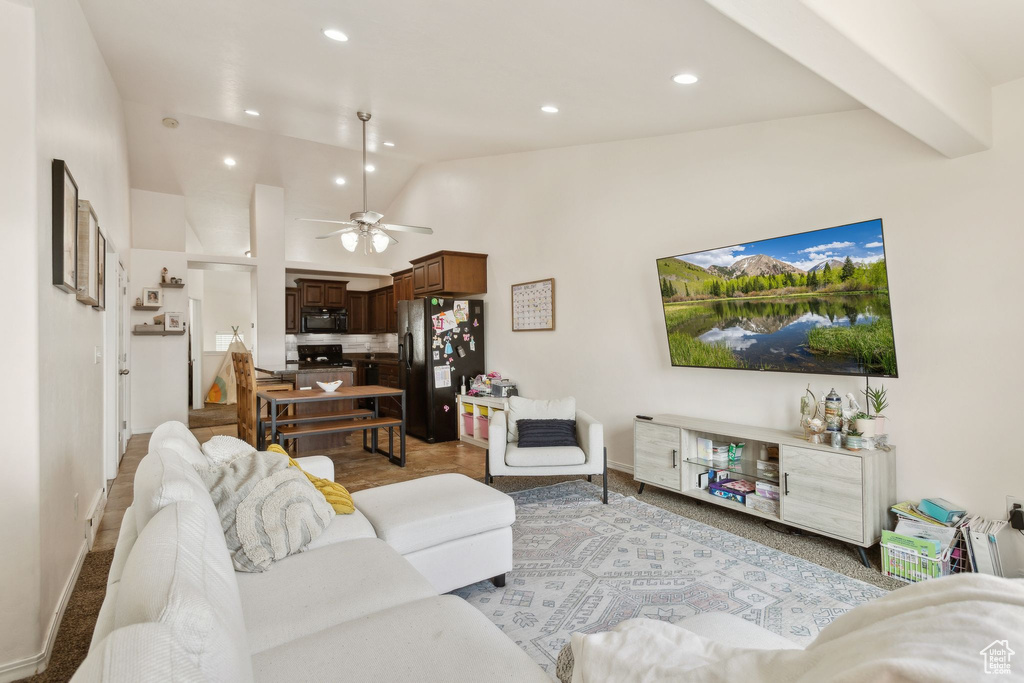 Living room featuring baseboards, ceiling fan, recessed lighting, and lofted ceiling