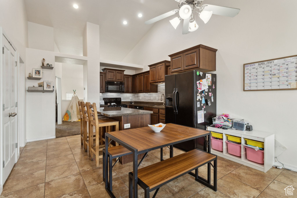 Dining area featuring a ceiling fan, high vaulted ceiling, recessed lighting, and baseboards