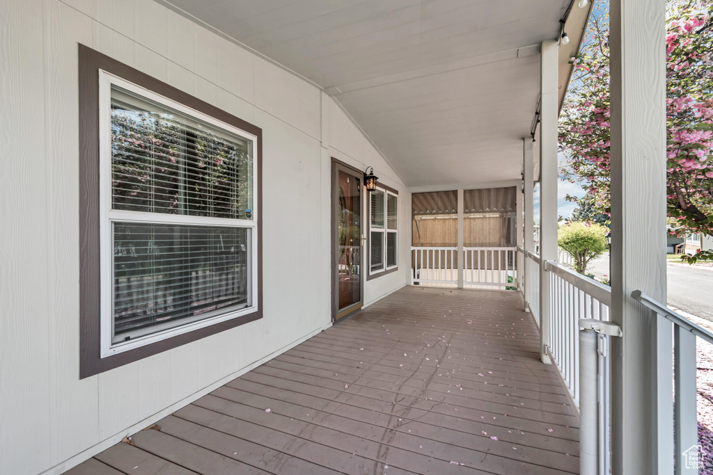 Wooden terrace featuring covered porch