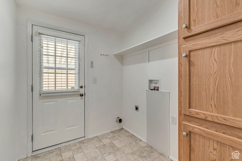 Laundry room featuring hookup for an electric dryer, laundry area, baseboards, and washer hookup