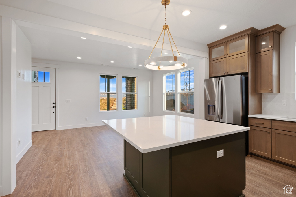 Kitchen featuring stainless steel refrigerator with ice dispenser, recessed lighting, light wood-style floors, and plenty of natural light