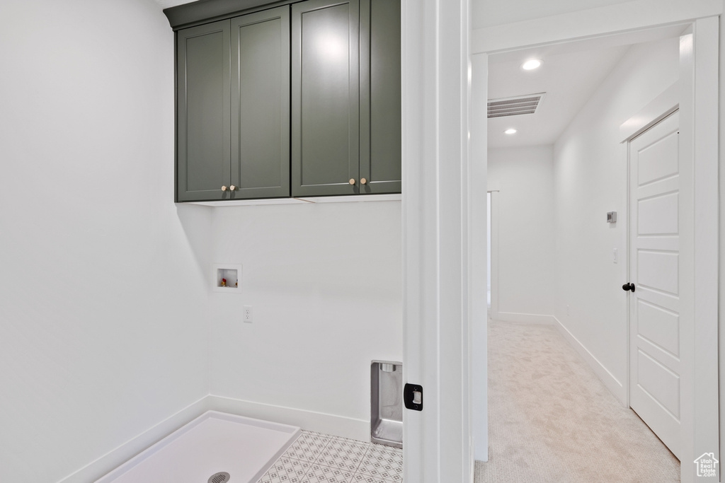 Washroom featuring cabinet space, recessed lighting, baseboards, and hookup for a washing machine