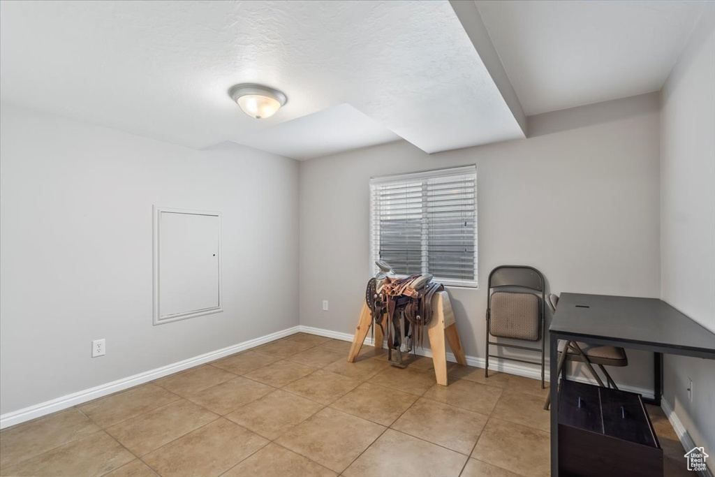 Office area featuring baseboards and light tile patterned floors