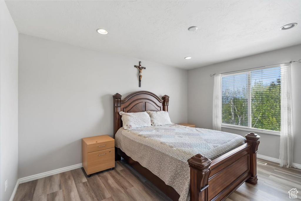 Bedroom with recessed lighting, baseboards, and light wood-type flooring