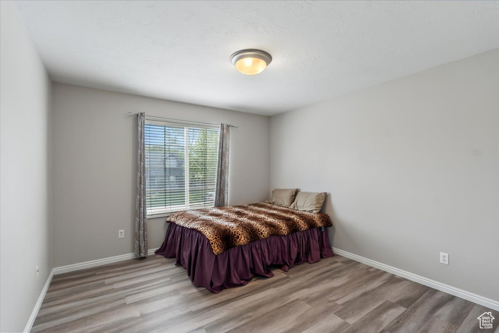 Bedroom featuring light wood-type flooring and baseboards