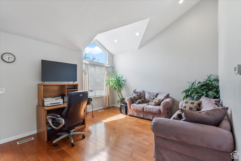 Office space with baseboards, recessed lighting, wood finished floors, and vaulted ceiling