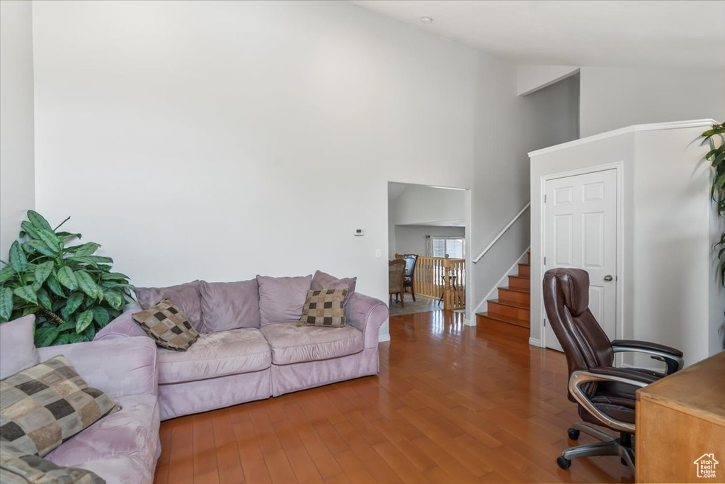 Office space with high vaulted ceiling and wood finished floors