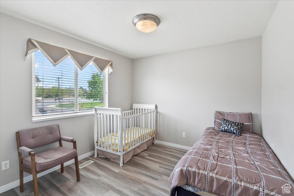 Bedroom with baseboards and wood finished floors