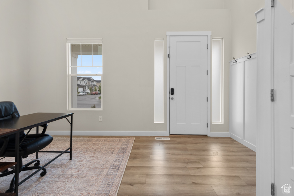 Office area with baseboards and wood finished floors