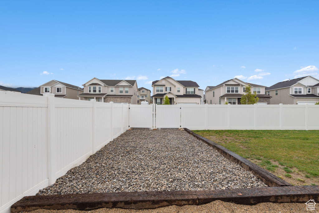 View of yard featuring a fenced backyard and a residential view