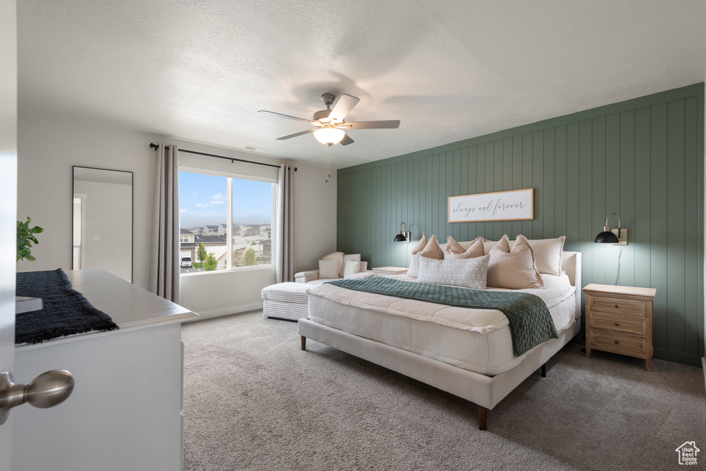 Carpeted bedroom featuring baseboards and ceiling fan