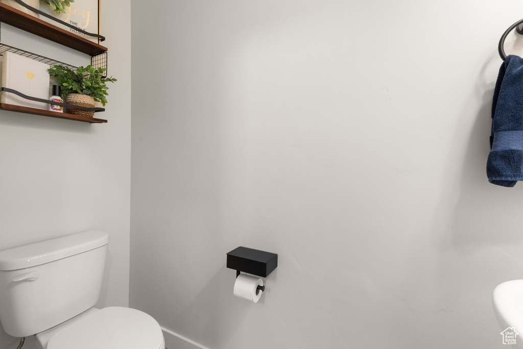 Bathroom with toilet and baseboards