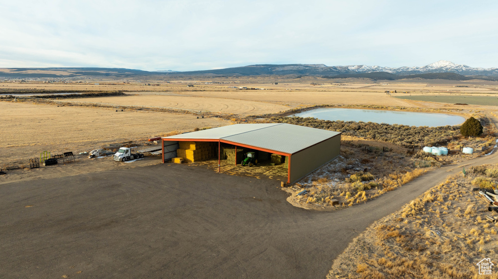 Birds eye view of property with a water and mountain view and a rural view