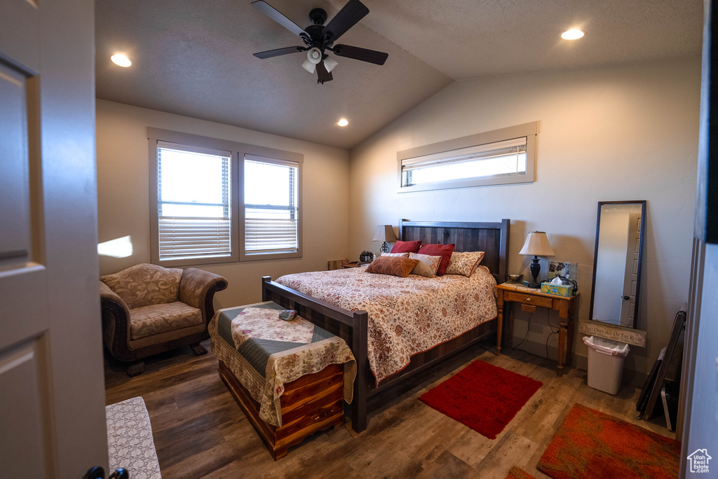 Bedroom with a ceiling fan, vaulted ceiling, recessed lighting, and wood finished floors