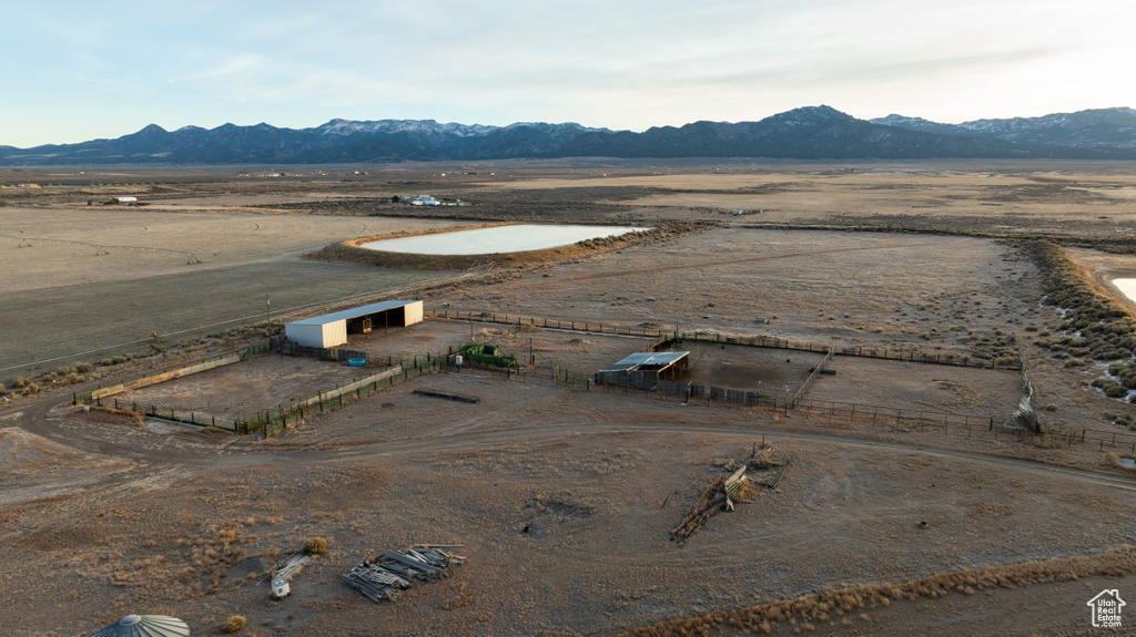 Drone / aerial view featuring view of desert, a mountain view, and a rural view