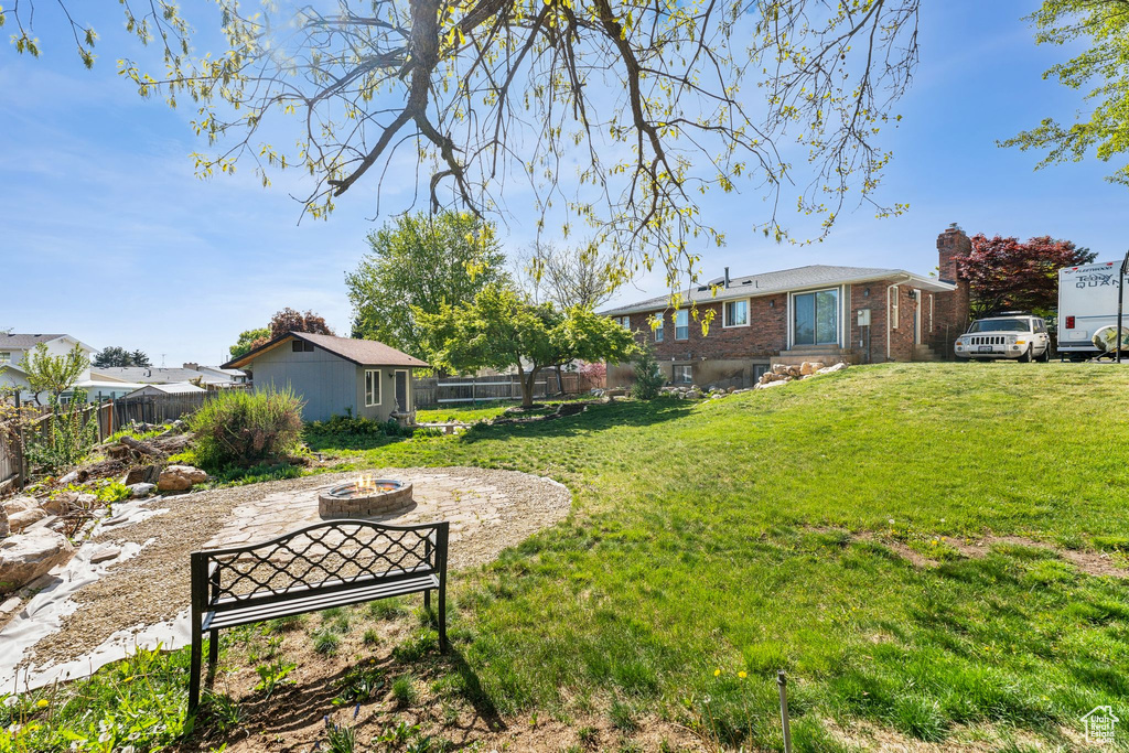 View of yard featuring a fenced backyard and an outdoor fire pit