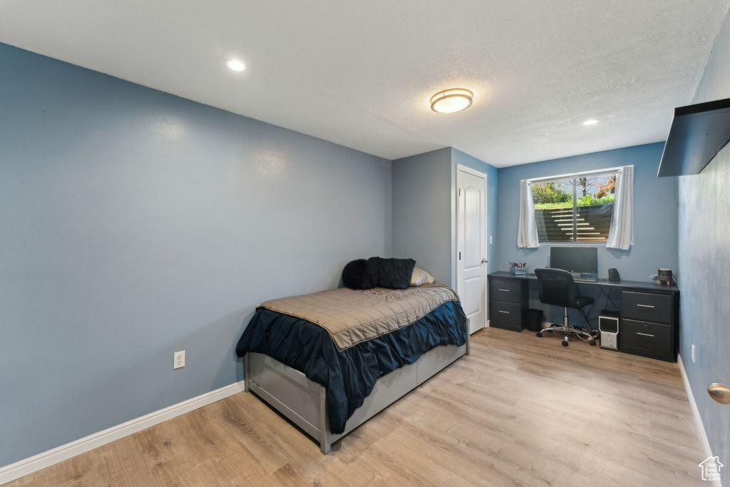 Bedroom featuring baseboards, recessed lighting, and wood finished floors