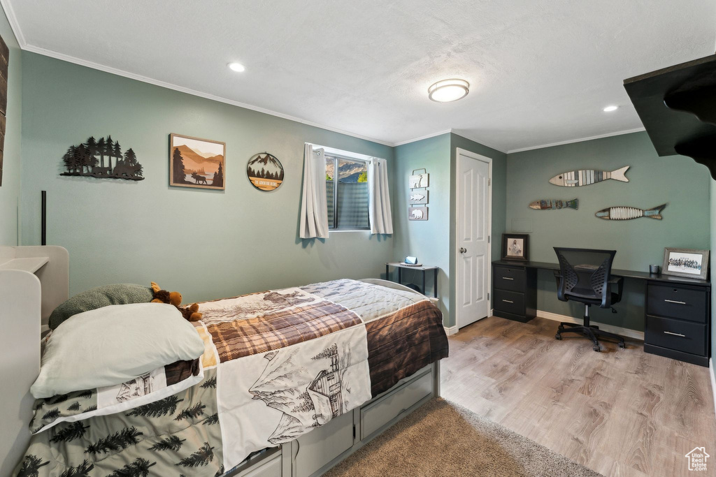 Bedroom featuring crown molding, baseboards, recessed lighting, and wood finished floors