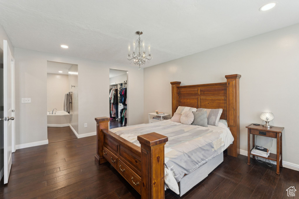Bedroom featuring baseboards, recessed lighting, dark wood-style flooring, and a chandelier