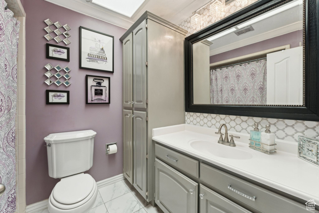 Full bathroom featuring visible vents, baseboards, vanity, toilet, and marble finish floor