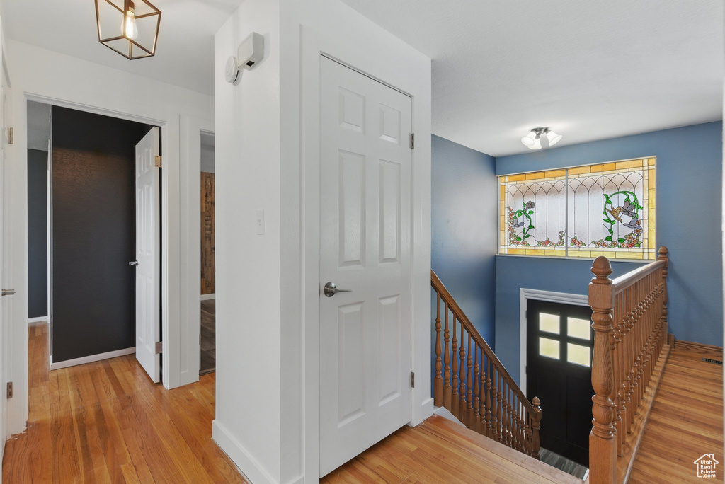 Entrance foyer with baseboards and wood finished floors
