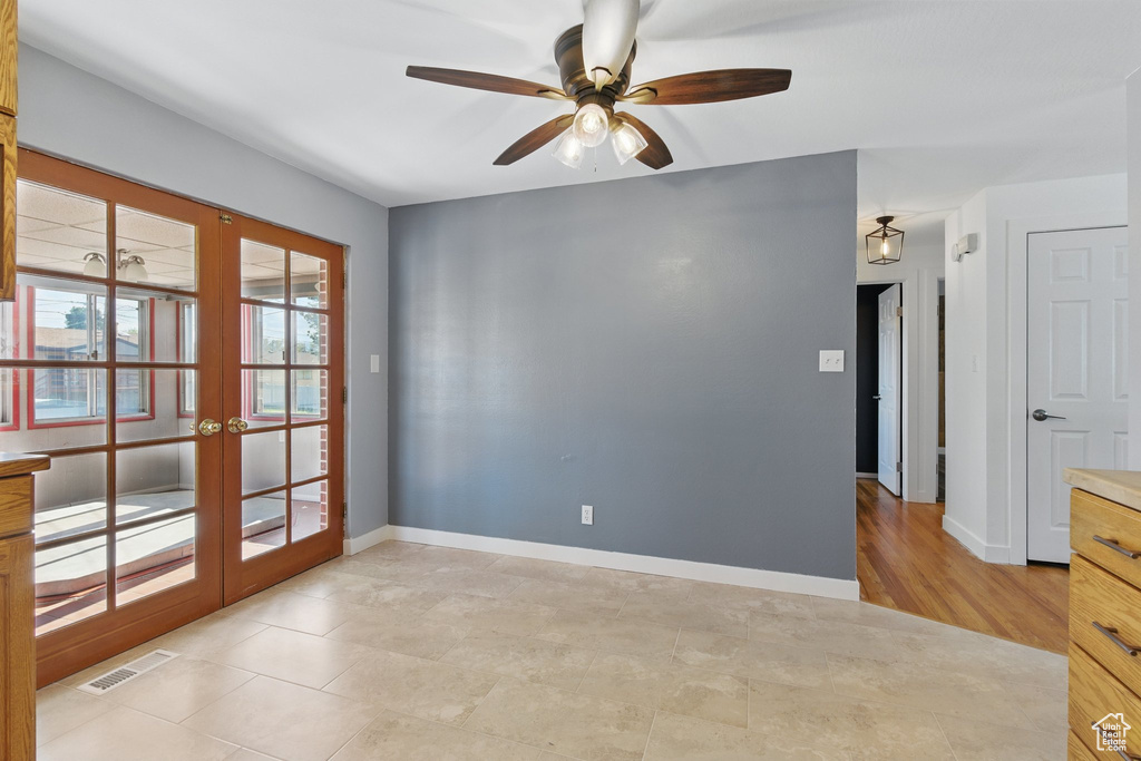 Unfurnished room with french doors, a ceiling fan, baseboards, and visible vents