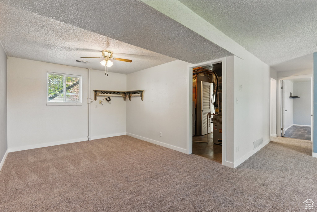 Unfurnished bedroom featuring visible vents, a textured ceiling, carpet, and baseboards