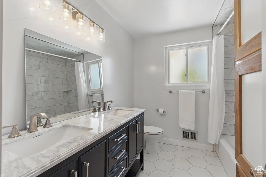 Full bathroom featuring a sink, visible vents, and a wealth of natural light