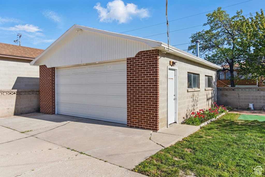 Detached garage featuring fence