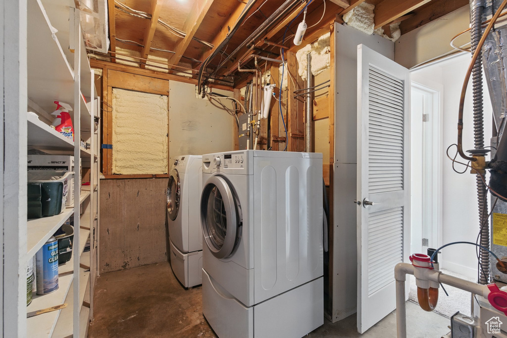 Washroom with washing machine and clothes dryer and laundry area