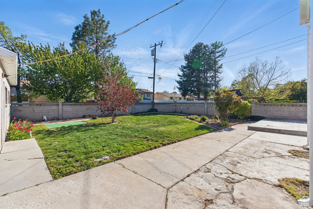 View of yard with a fenced backyard and a patio